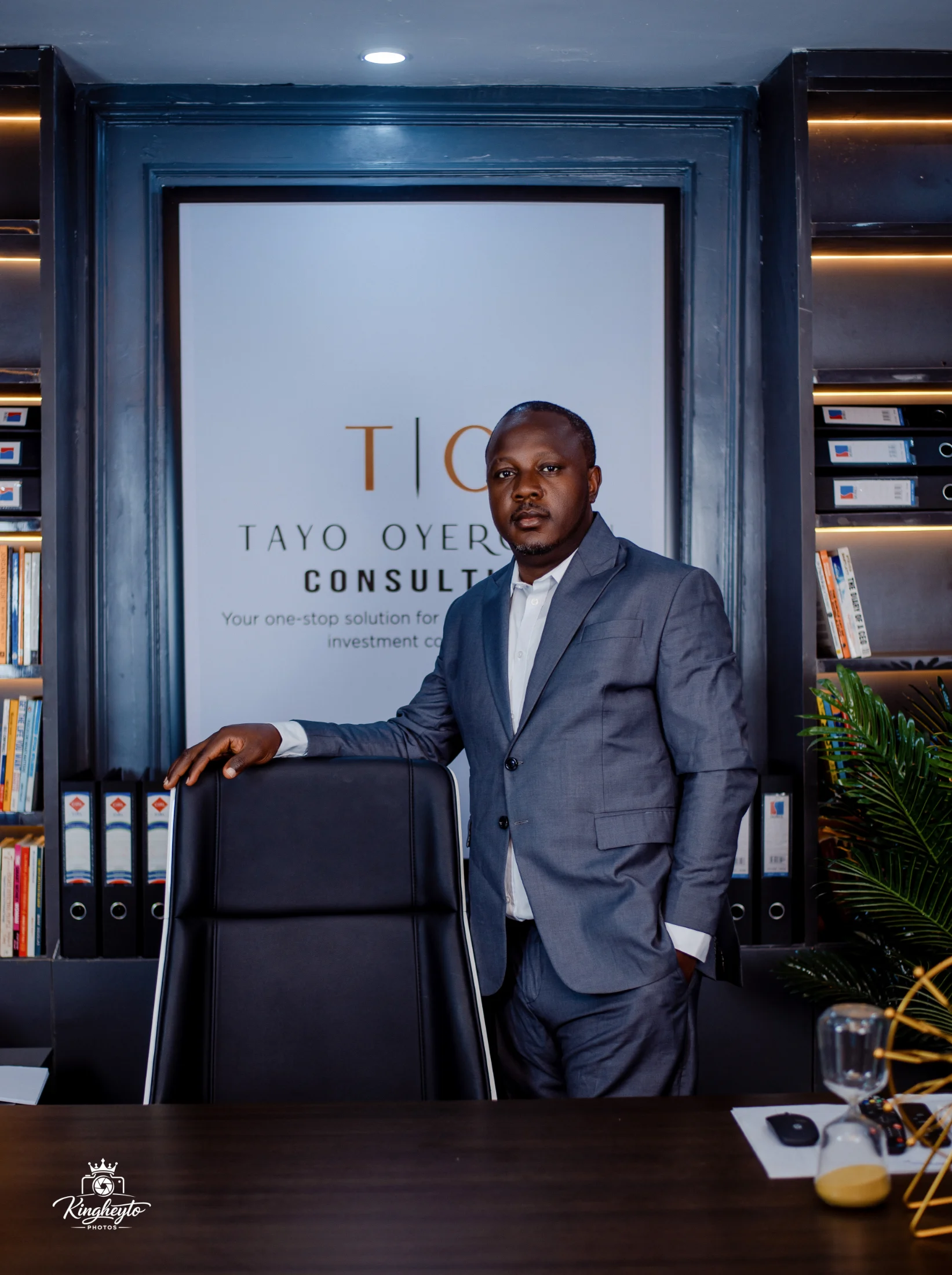 Engr. Omotayo Oyerokun standing beside his office chair